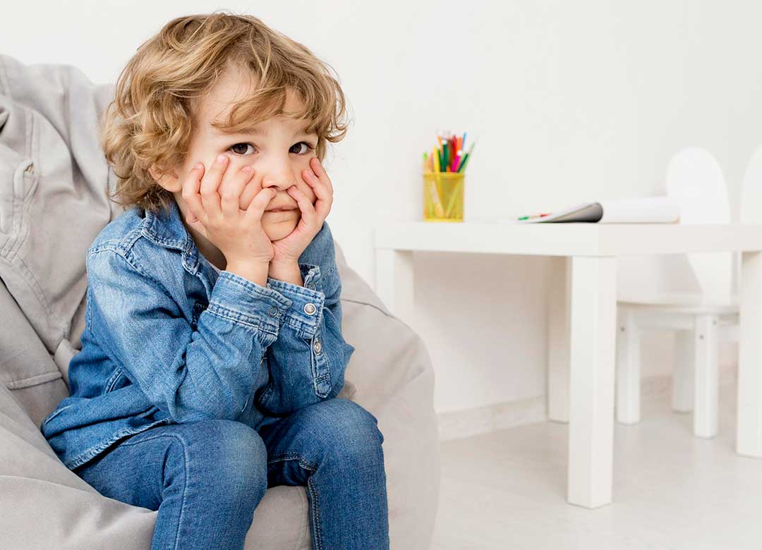 Young child waiting in a therapy clinic environment, representing the challenge of pediatric therapy access and wait times.